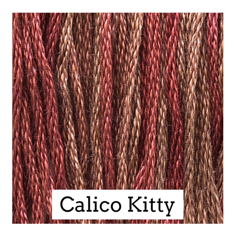A variegated swatch of Classic Colorworks floss in the colors muted red and brown.