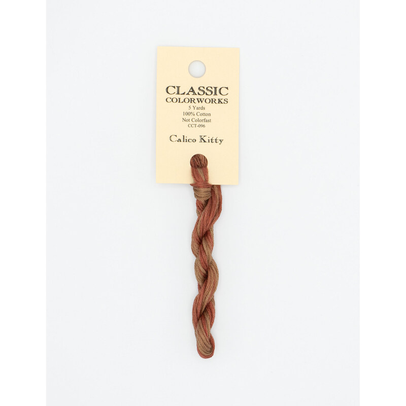 A skein of variegated muted red and brown embroidery floss, twisted and bundled, with a cream and black label featuring the brand name and color information.
