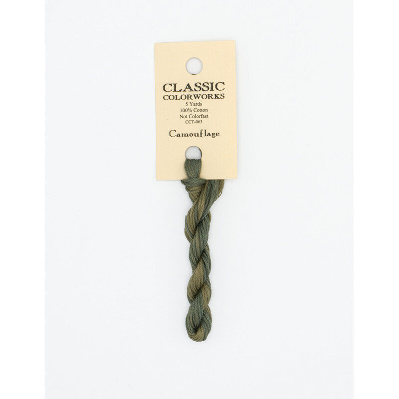 A skein of muted sage embroidery floss, twisted and bundled, with a cream and black label featuring the brand name and color information.