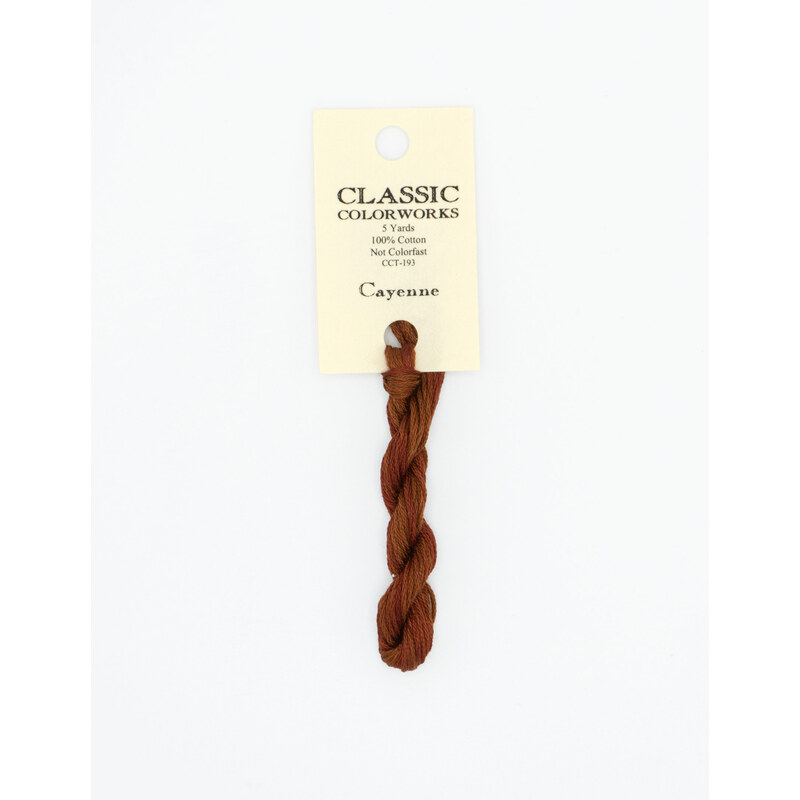 A skein of mahogany red embroidery floss, twisted and bundled, with a cream and black label featuring the brand name and color information.
