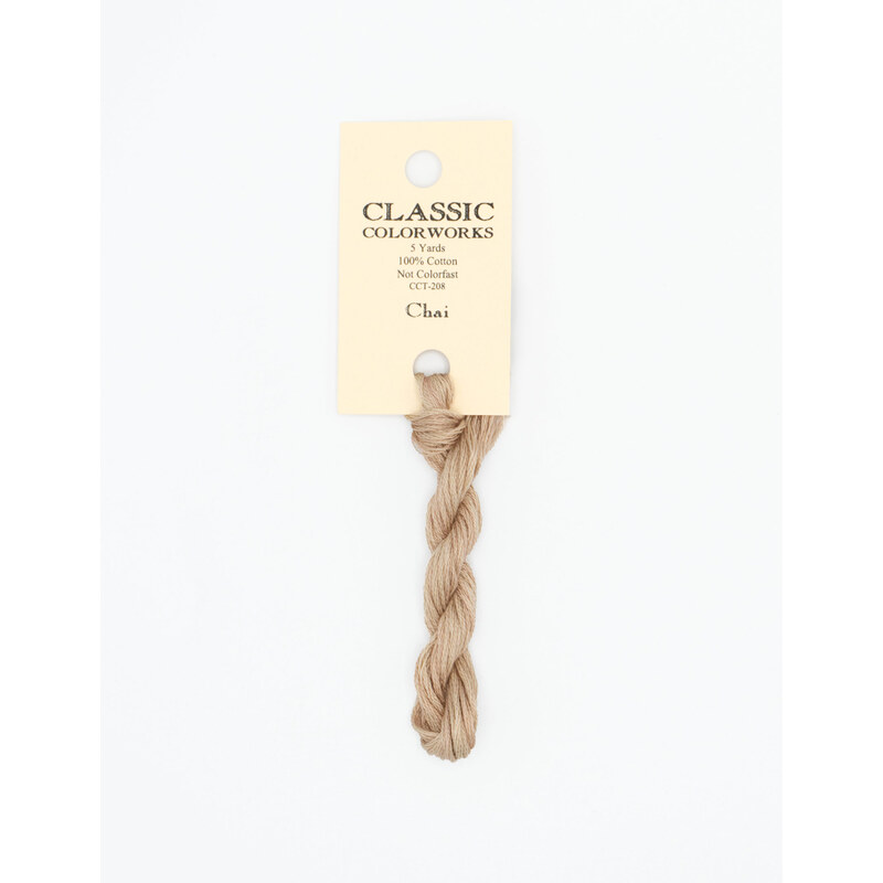 A skein of latte brown embroidery floss, twisted and bundled, with a cream and black label featuring the brand name and color information.