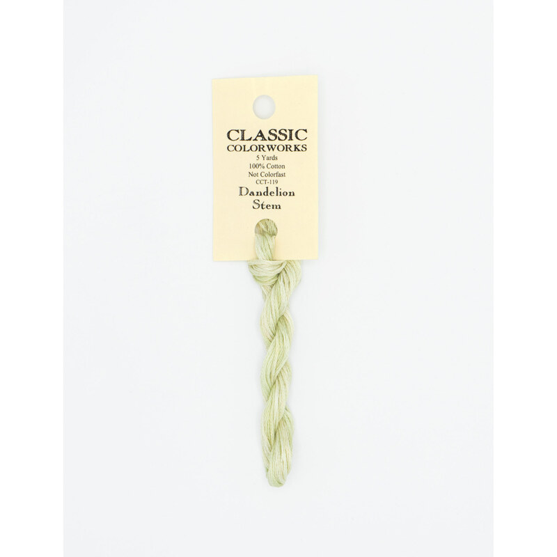 A skein of light green embroidery floss, twisted and bundled, with a cream and black label featuring the brand name and color information.