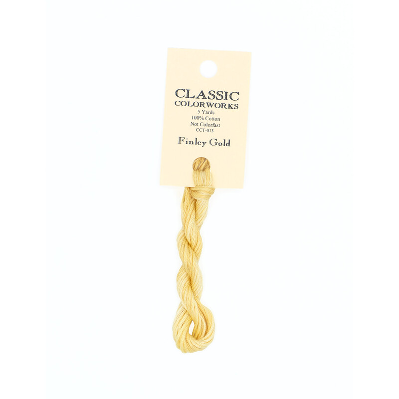 A skein of yellow embroidery floss, twisted and bundled, with a cream and black label featuring the brand name and color information.