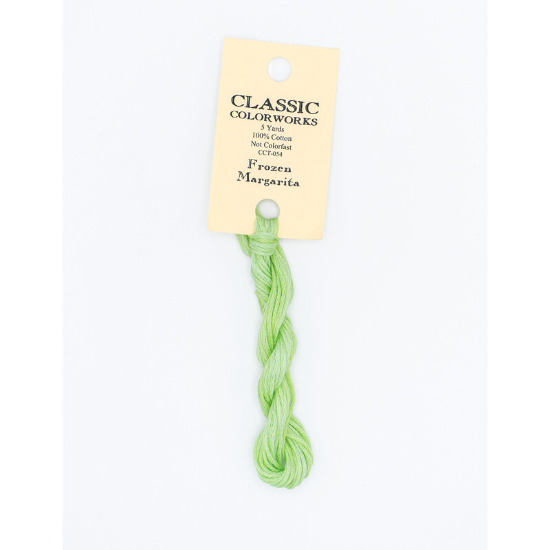A skein of spring green embroidery floss, twisted and bundled, with a cream and black label featuring the brand name and color information.