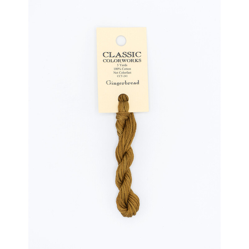 A skein of suede brown embroidery floss, twisted and bundled, with a cream and black label featuring the brand name and color information.