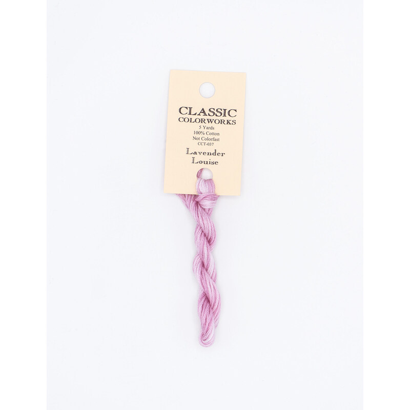 A skein of lilac pink embroidery floss, twisted and bundled, with a cream and black label featuring the brand name and color information.
