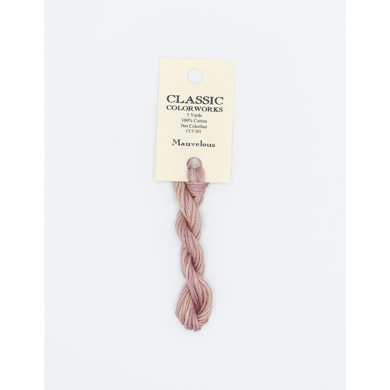 A skein of light purple embroidery floss, twisted and bundled, with a cream and black label featuring the brand name and color information.