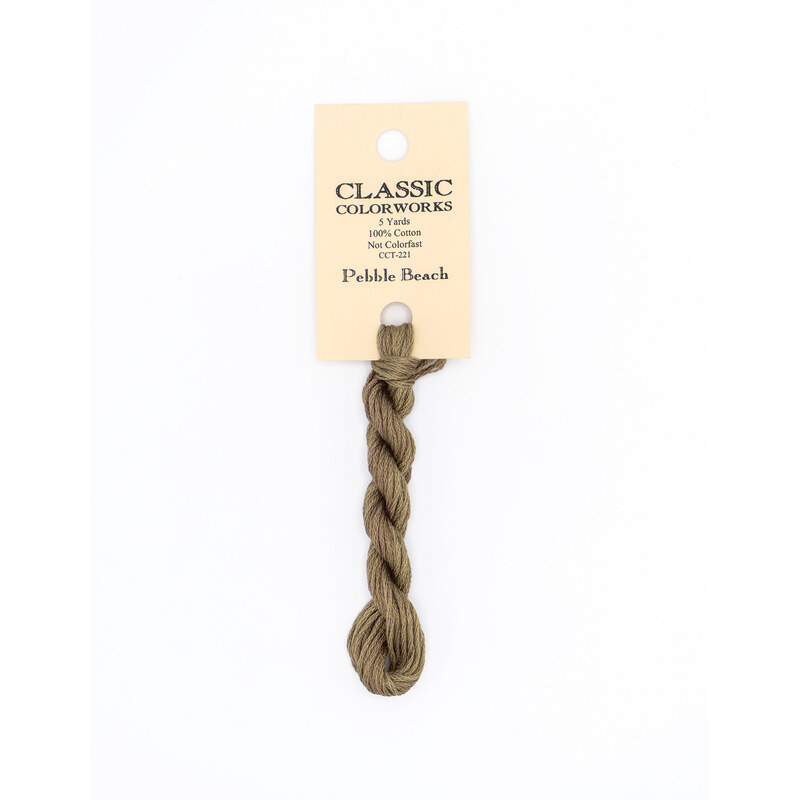 A skein of gray brown embroidery floss, twisted and bundled, with a cream and black label featuring the brand name and color information.