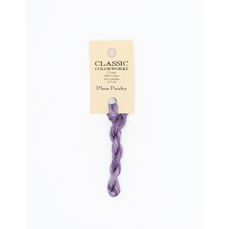 A skein of light plum embroidery floss, twisted and bundled, with a cream and black label featuring the brand name and color information.