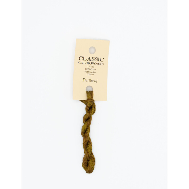 A skein of suede brown embroidery floss, twisted and bundled, with a cream and black label featuring the brand name and color information.