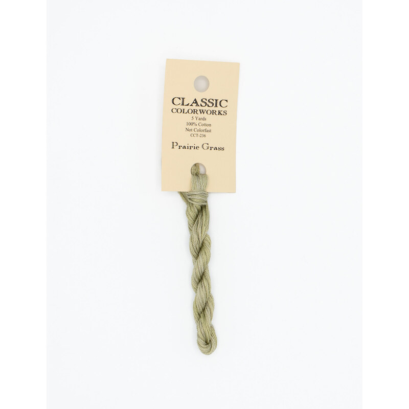 A skein of khaki green embroidery floss, twisted and bundled, with a cream and black label featuring the brand name and color information.