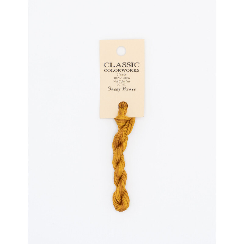 A skein of sienna embroidery floss, twisted and bundled, with a cream and black label featuring the brand name and color information.
