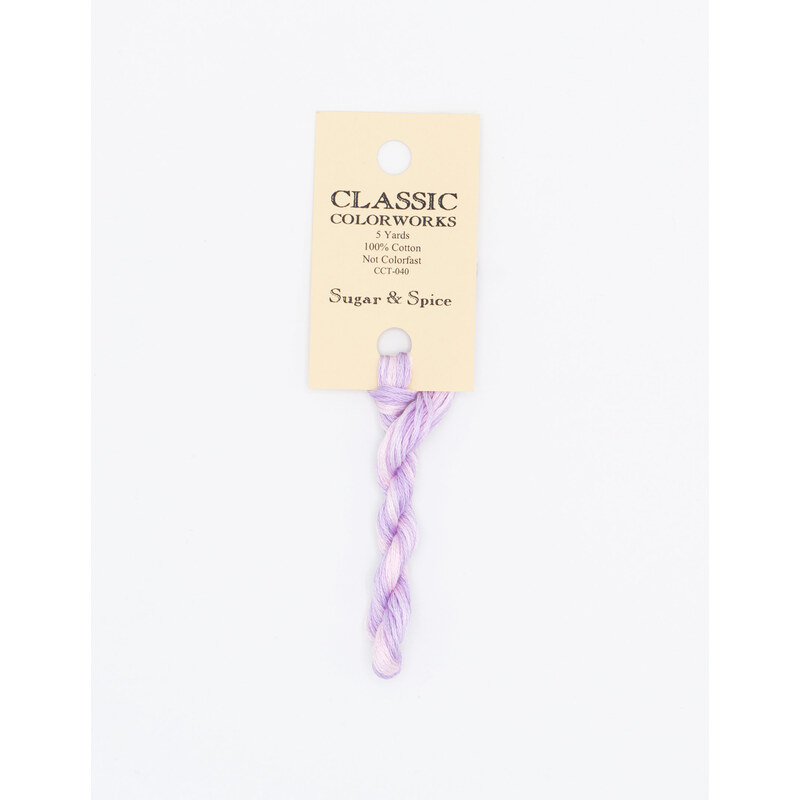 A skein of light purple embroidery floss, twisted and bundled, with a cream and black label featuring the brand name and color information.