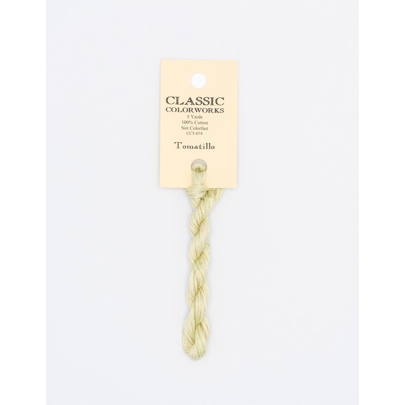 A skein of light yellow embroidery floss, twisted and bundled, with a cream and black label featuring the brand name and color information.