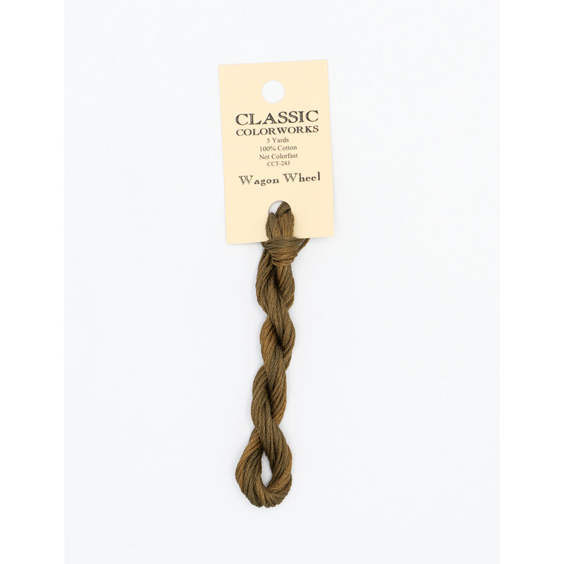 A skein of brown embroidery floss, twisted and bundled, with a cream and black label featuring the brand name and color information.