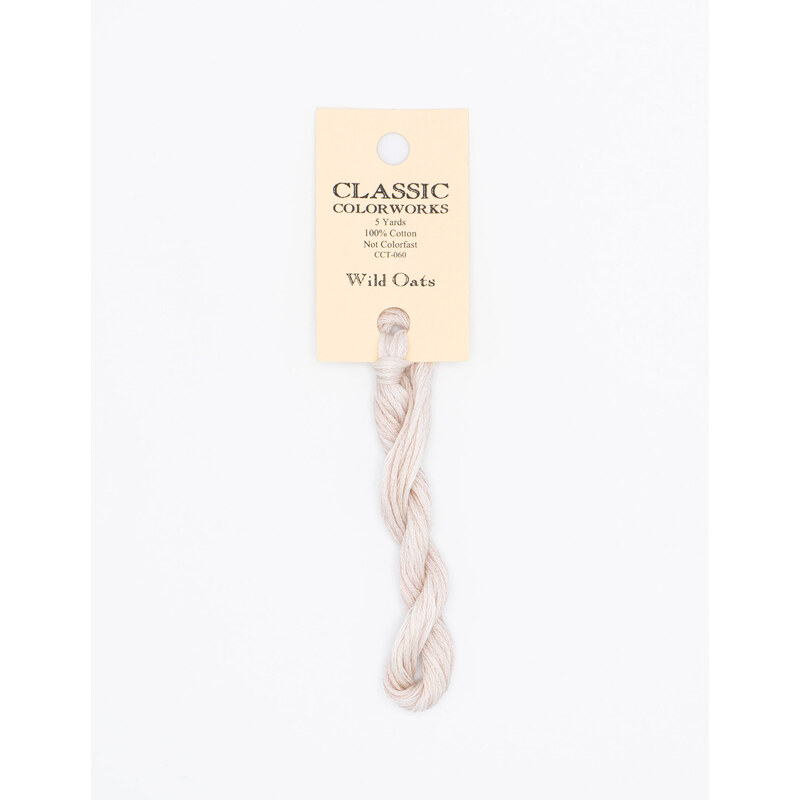 A skein of linen embroidery floss, twisted and bundled, with a cream and black label featuring the brand name and color information.