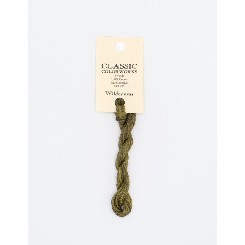 A skein of sage green embroidery floss, twisted and bundled, with a cream and black label featuring the brand name and color information.