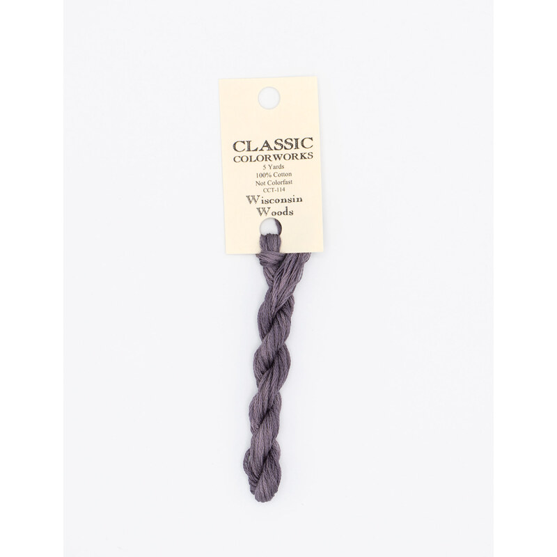 A skein of dark lilac embroidery floss, twisted and bundled, with a cream and black label featuring the brand name and color information.