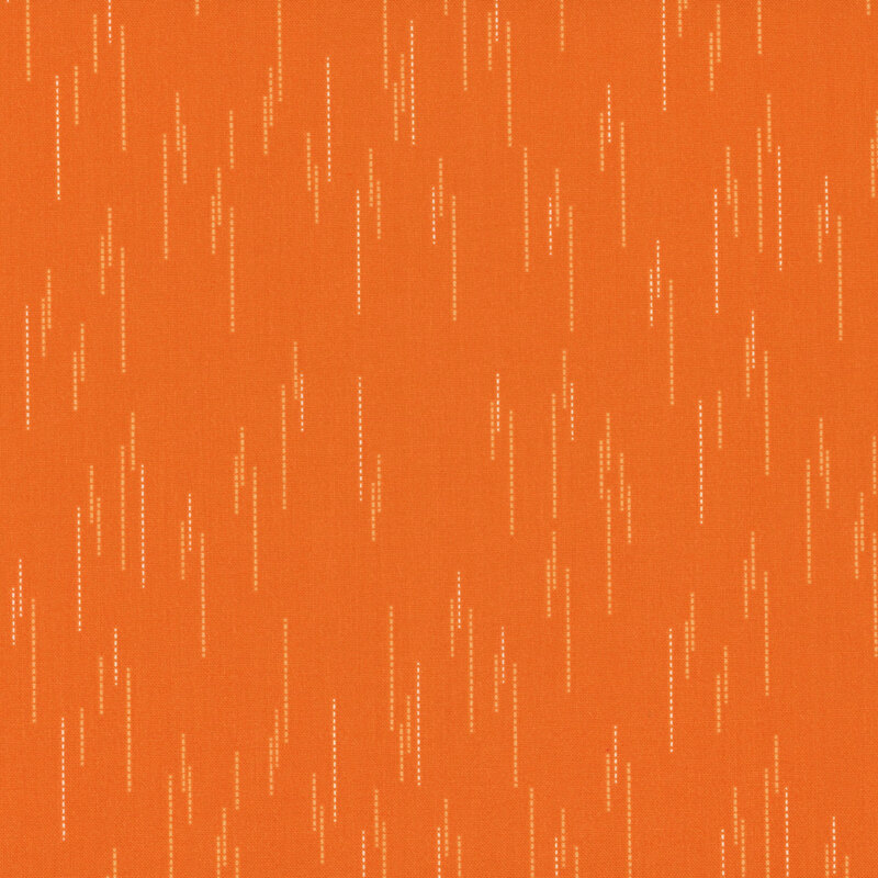 Orange fabric with a pattern of spaced apart dotted lines.