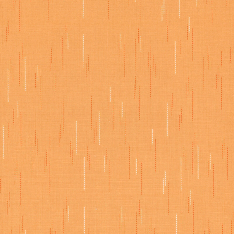 Pale orange fabric with a pattern of spaced apart dotted lines.