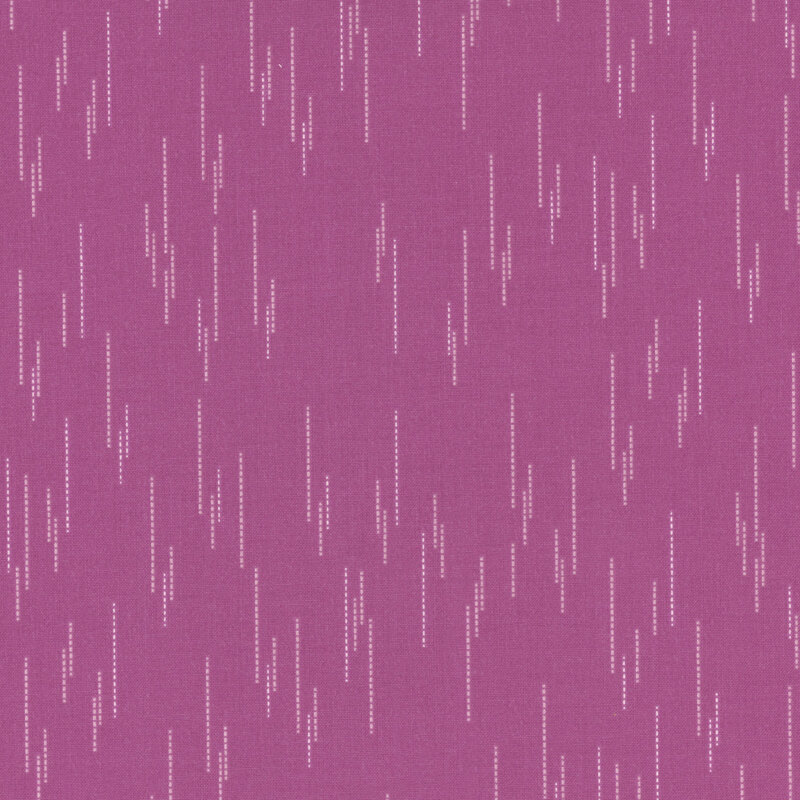 Magenta fabric with a pattern of spaced apart dotted lines.