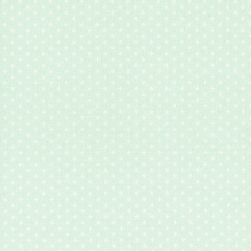 Mint green fabric with a pattern of small, white, geometric diamond shapes. 