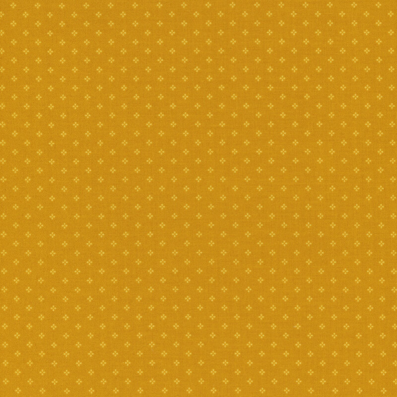 Golden yellow fabric with a pattern of small, tonal, geometric diamond shapes. 
