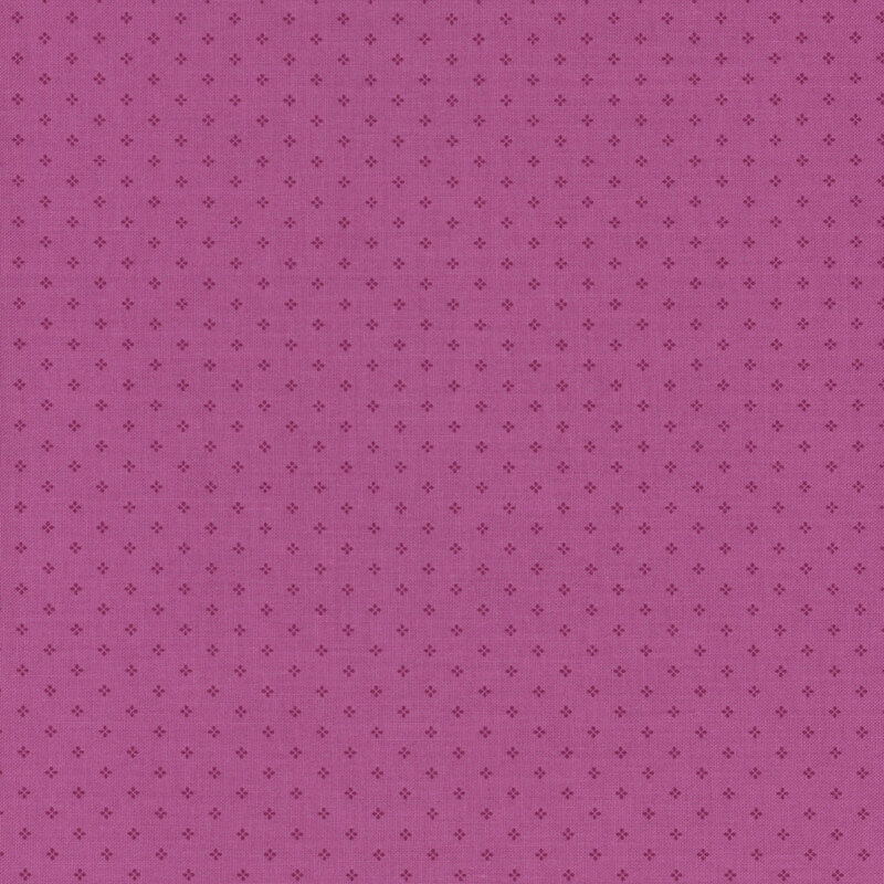 Magenta fabric with a pattern of small, tonal, geometric diamond shapes. 