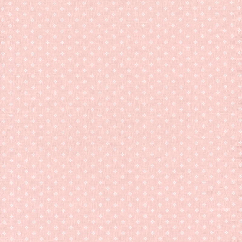 Pink fabric with a pattern of small, white, geometric diamond shapes. 