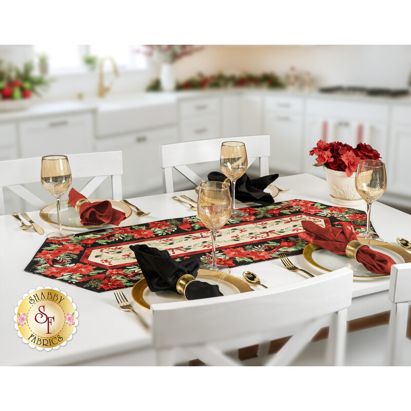 The completed Easy Striped Table Runner colored in floral red, cream, and black fabrics from the Cardinal Celebration collection by Timeless Treasures Fabrics, staged on a white table with four coordinating table settings.
