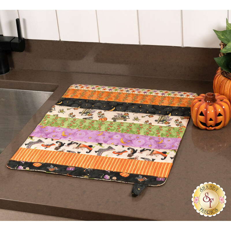 The completed Dry Ideas project, colored in Halloween fabrics from the Ghoul Friends collection, staged on a kitchen counter beside the sink.