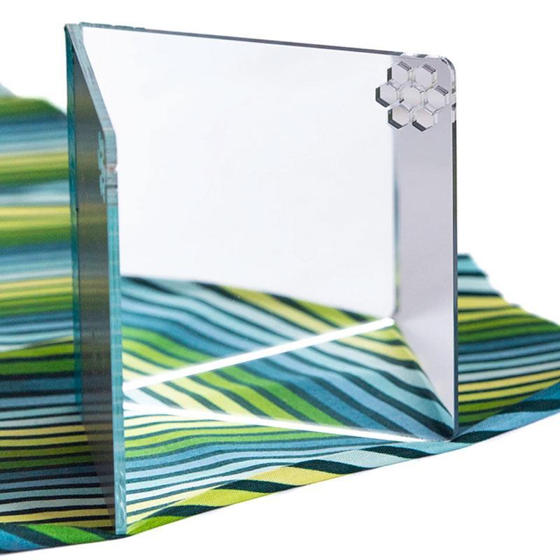 The Paper Pieces MirroSCOPE mirror staged on a piece of fabric to show the mirrored effect.