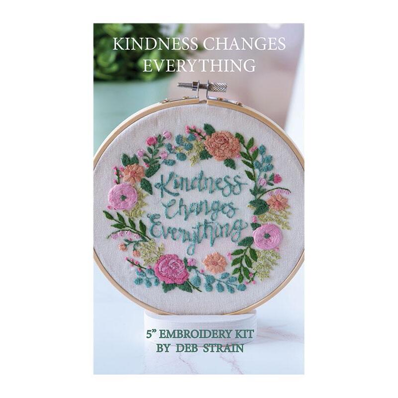 The cover of the hand embroidery kit displaying the completed project: the phrase 