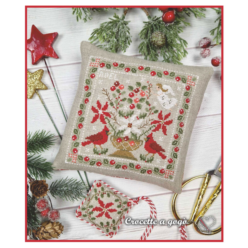 The completed project, a christmas floral design with a small scissor fob, staged with coordinating holiday decor.