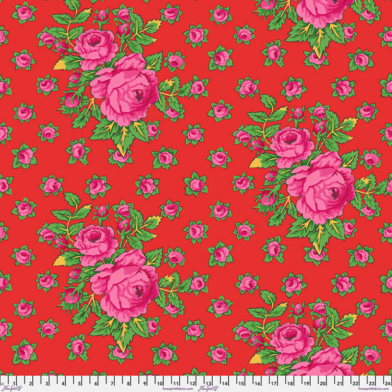 Tomato red fabric with bright pink roses with small rosebuds in the background.