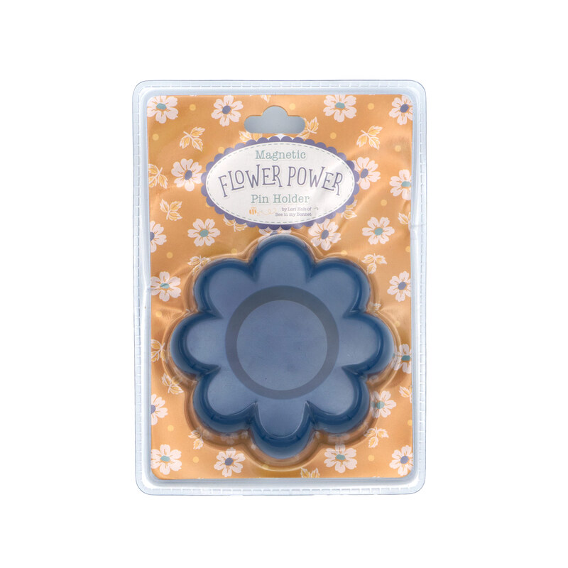 A denim blue flower-shaped magnetic dish with a central indentation.