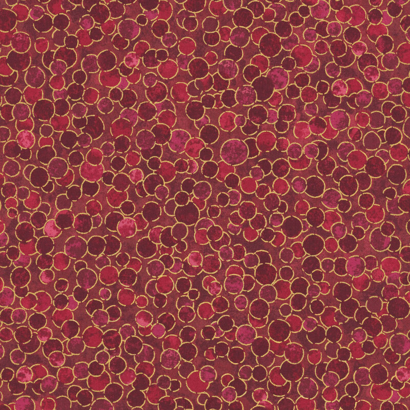 mottled deep red fabric with outlined with overlapping gold metallic dots