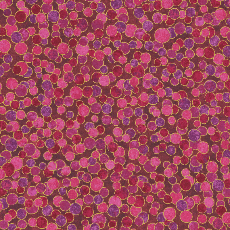 pink and purple mottled fabric featuring gold metallic outlined and overlapping dots