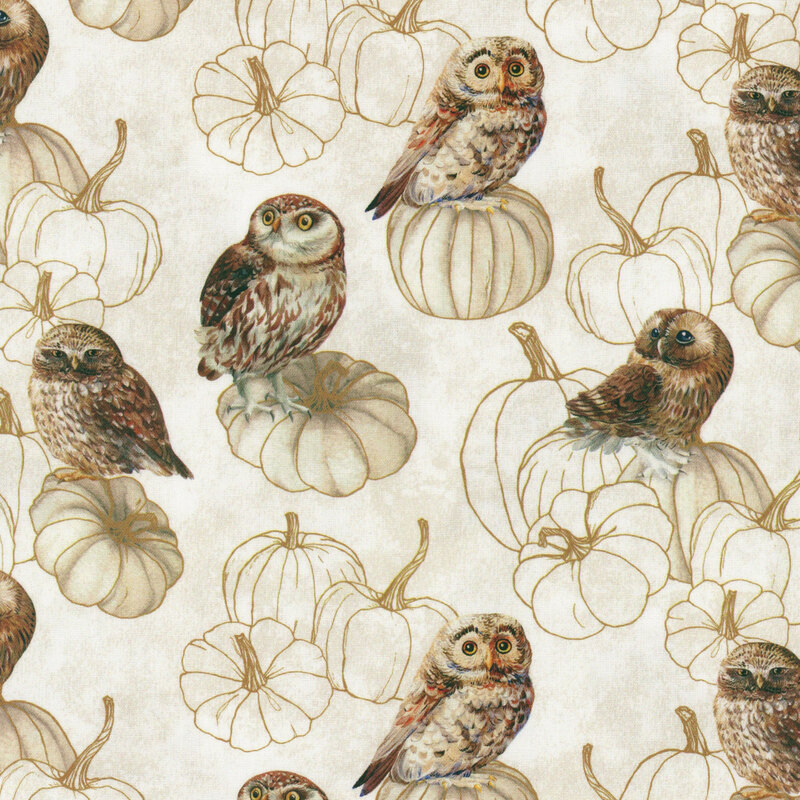 mottled cream fabric featuring owls resting on stacks of stylized pumpkins