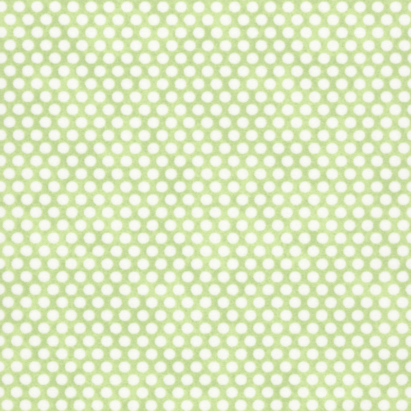 Mottled green fabric with neat rows of small white polka dots.