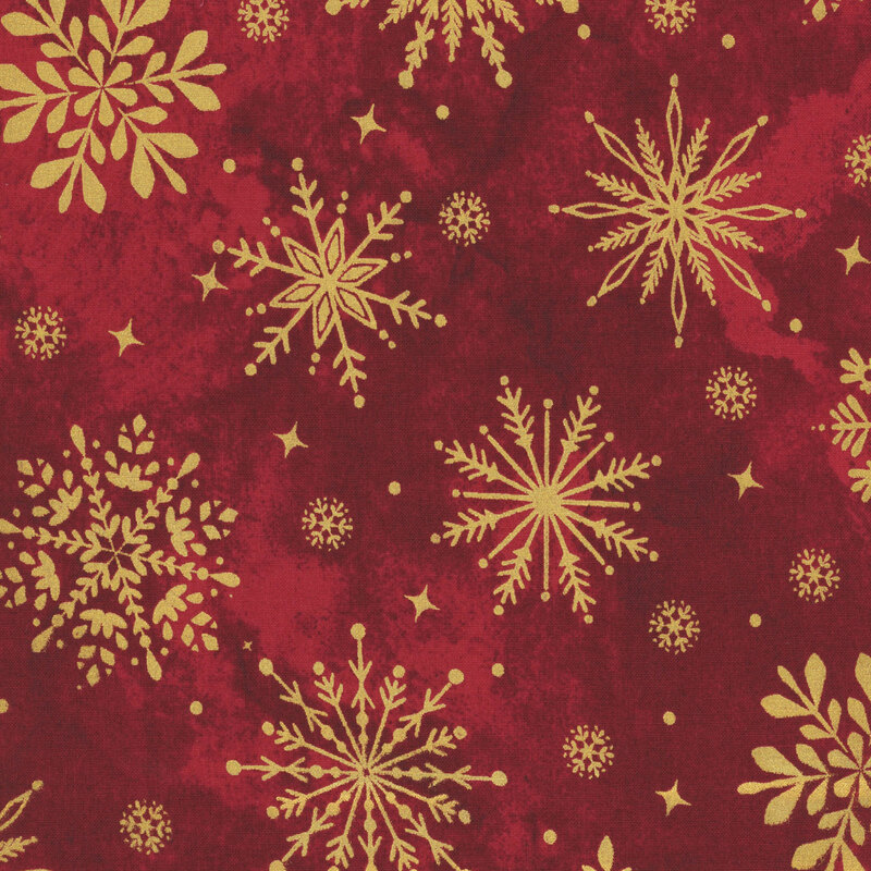 Mottled deep red fabric featuring gold metallic stylized snowflakes, dots, and stars.
