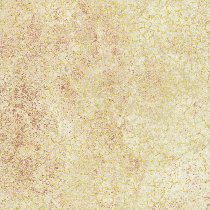 A mottled sand colored fabric with cracked texture and gold metallic accents