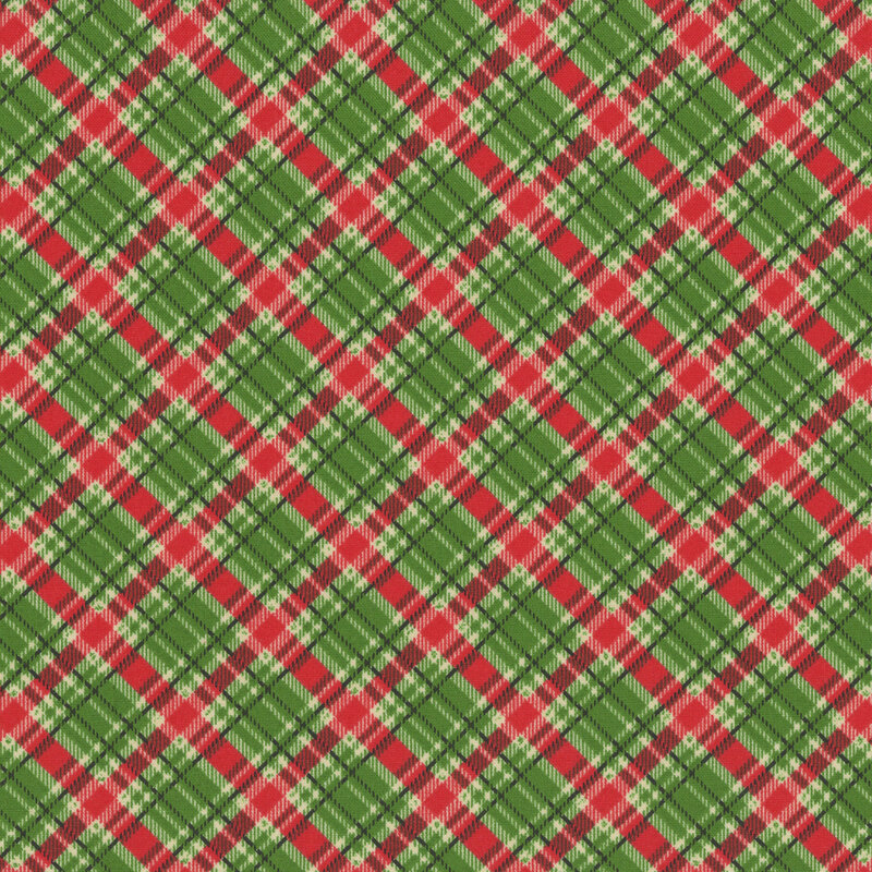Green fabric with a classic plaid pattern in red, black, and cream.
