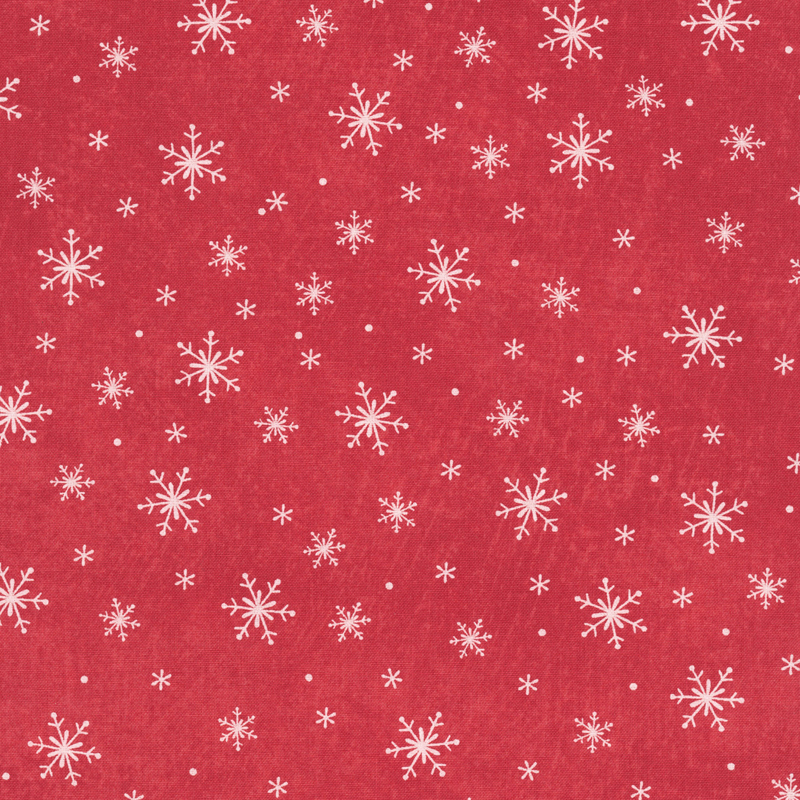 textured cardinal red fabric tossed with white snowflakes