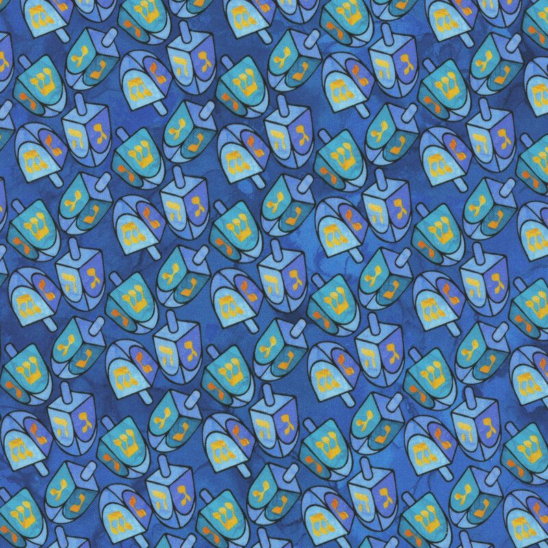 A blue Hanukkah themed fabric featuring scattered stained glass dreidels. 