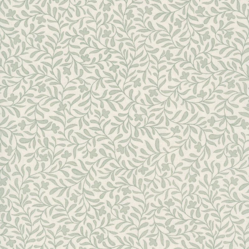 An eggshell white fabric with a light sage leafy vine design 