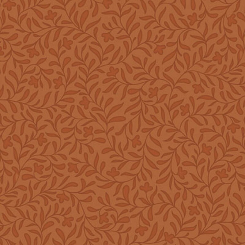 A pumpkin orange fabric with a dense tonal leafy vine design