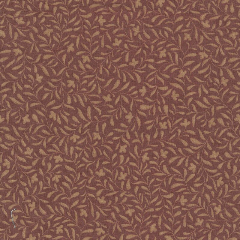 A chestnut fabric with a light brown leafy vine design
