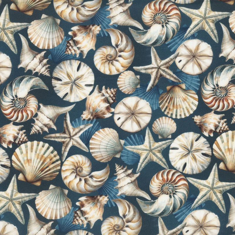 Navy blue fabric scattered with various seashells in tans and browns.