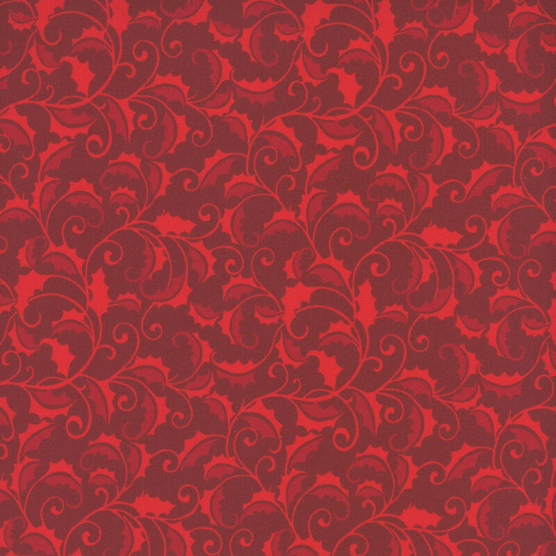 A cranberry red fabric with a swirly bright red pattern of holly leaves and vines.